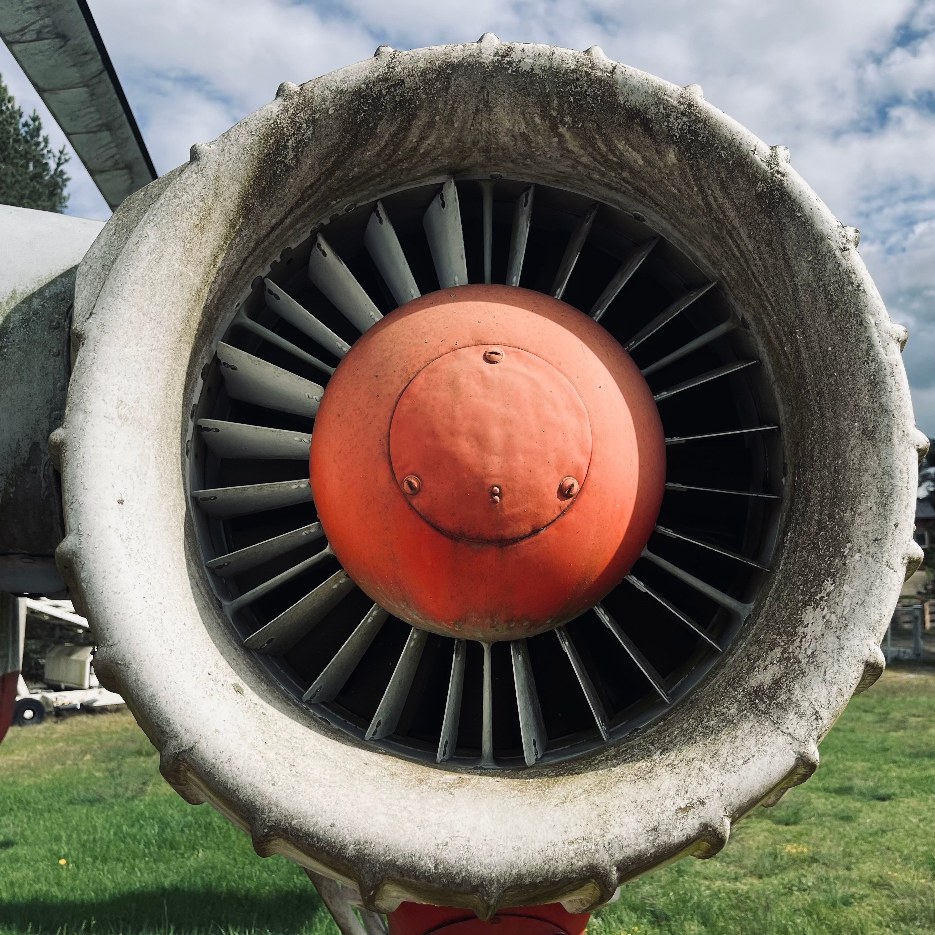 A detailed view of a vintage airplane turbine engine, showcasing its weathered look.