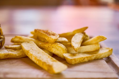 Free Fries on Brown Table Stock Photo