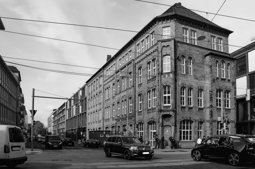 Free Black and white photo of a historic street corner in Braunschweig, Germany with classic architecture and cars. Stock Photo