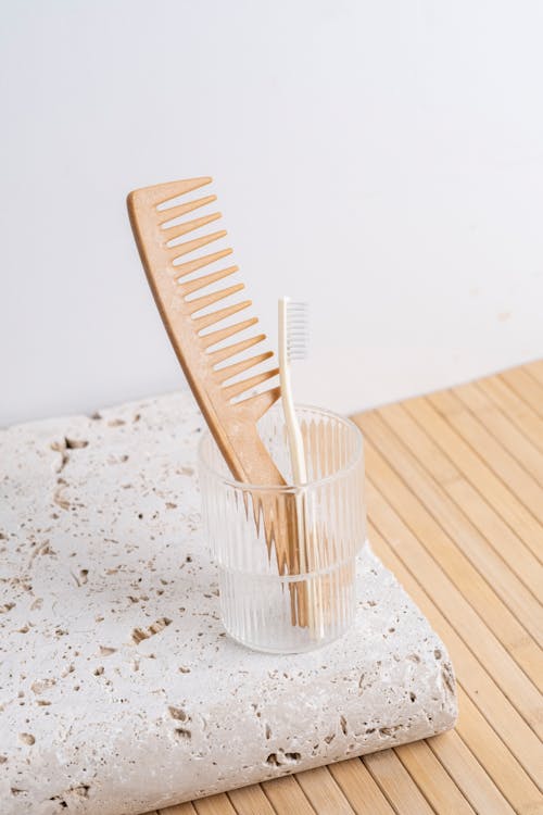Wooden Comb and Toothbrush in a Bathroom 