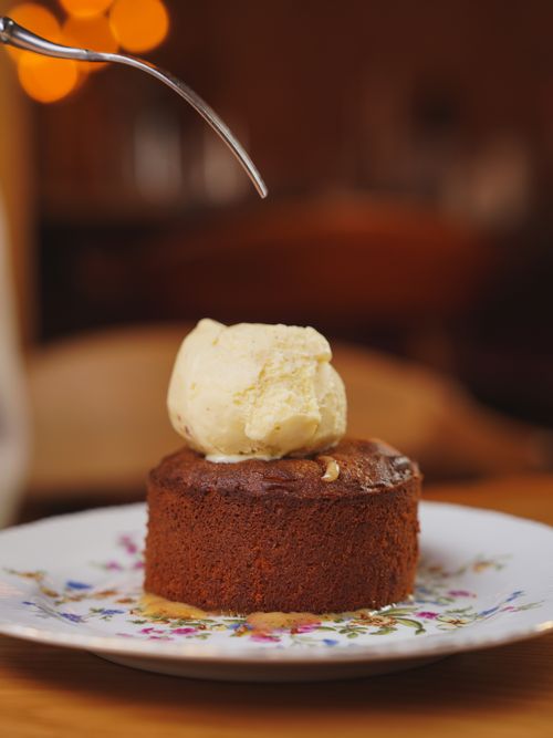 Free Close-up of a chocolate cake with a scoop of vanilla ice cream on top, ready to be savored. Stock Photo