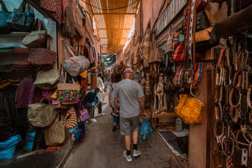 Free Explore the bustling souk in Marrakech with colorful textiles and local crafts on display. Stock Photo