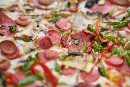 A close-up of a pizza with pepperoni, vegetables, and mushrooms, ideal for food lovers.