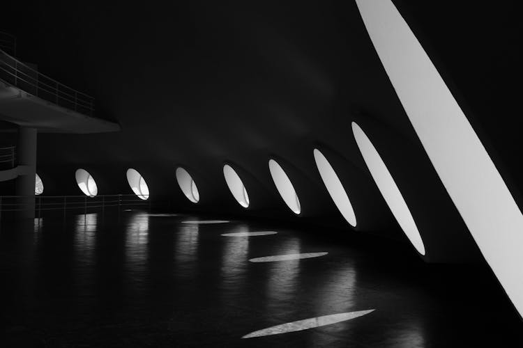 Black And White Photography Of Building With Round Windows