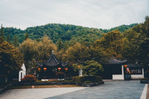 Free Charming pagoda set against lush green hills, capturing the essence of Asian heritage. Stock Photo