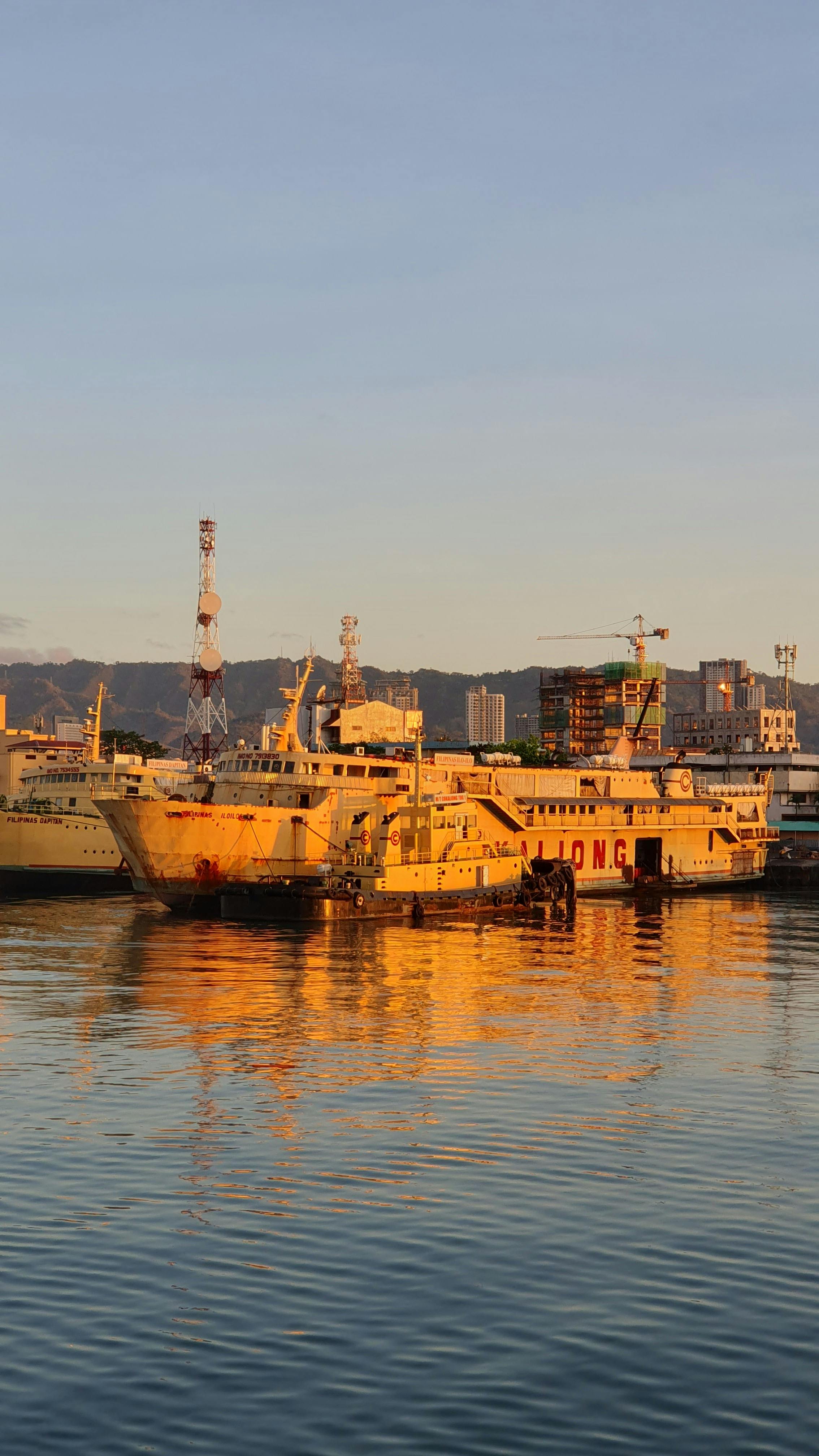 ship in harbor during sunset