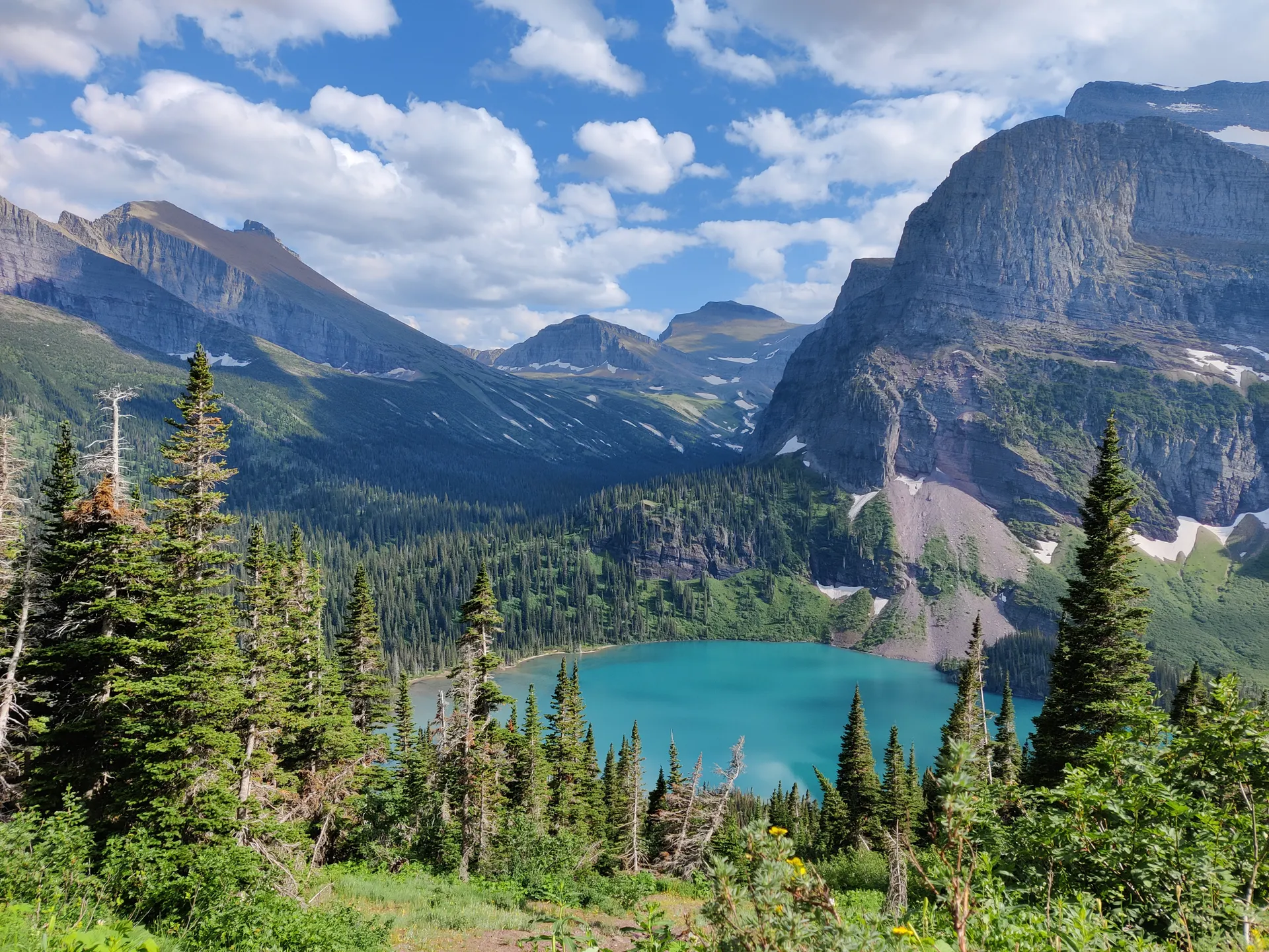 View of a mountain lake surrounded by forest in Glacier National Park, Montana. View of a mountain lake surrounded by forest in Glacier National Park, Montana.