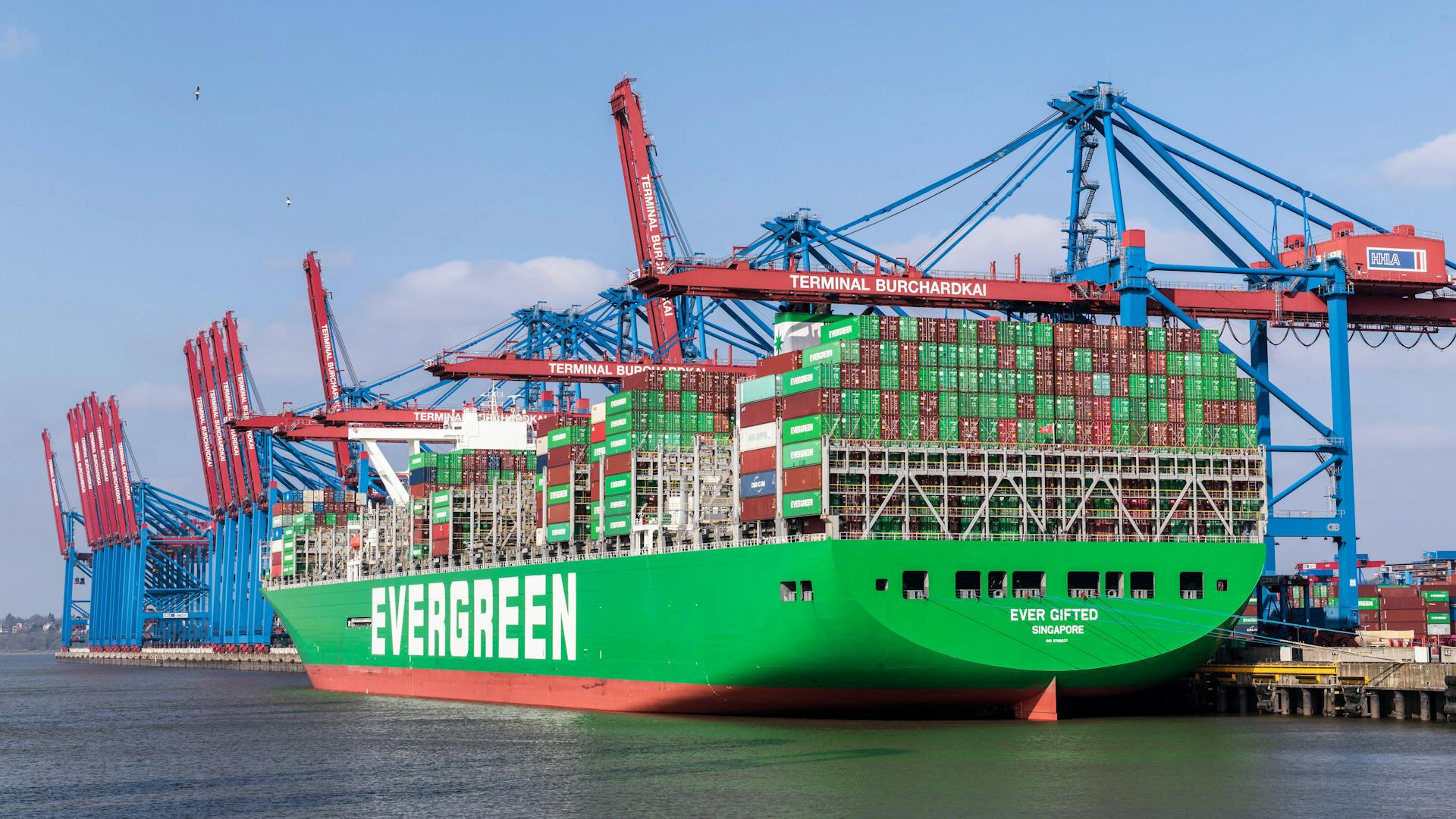 Evergreen Cargo Ship in Harbor under Blue Sky