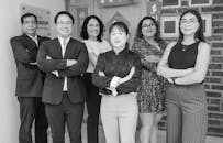 Men and Women Standing and Smiling in Black and White