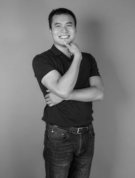 Studio portrait of a smiling man in casual fashion. Black and white elegance.
