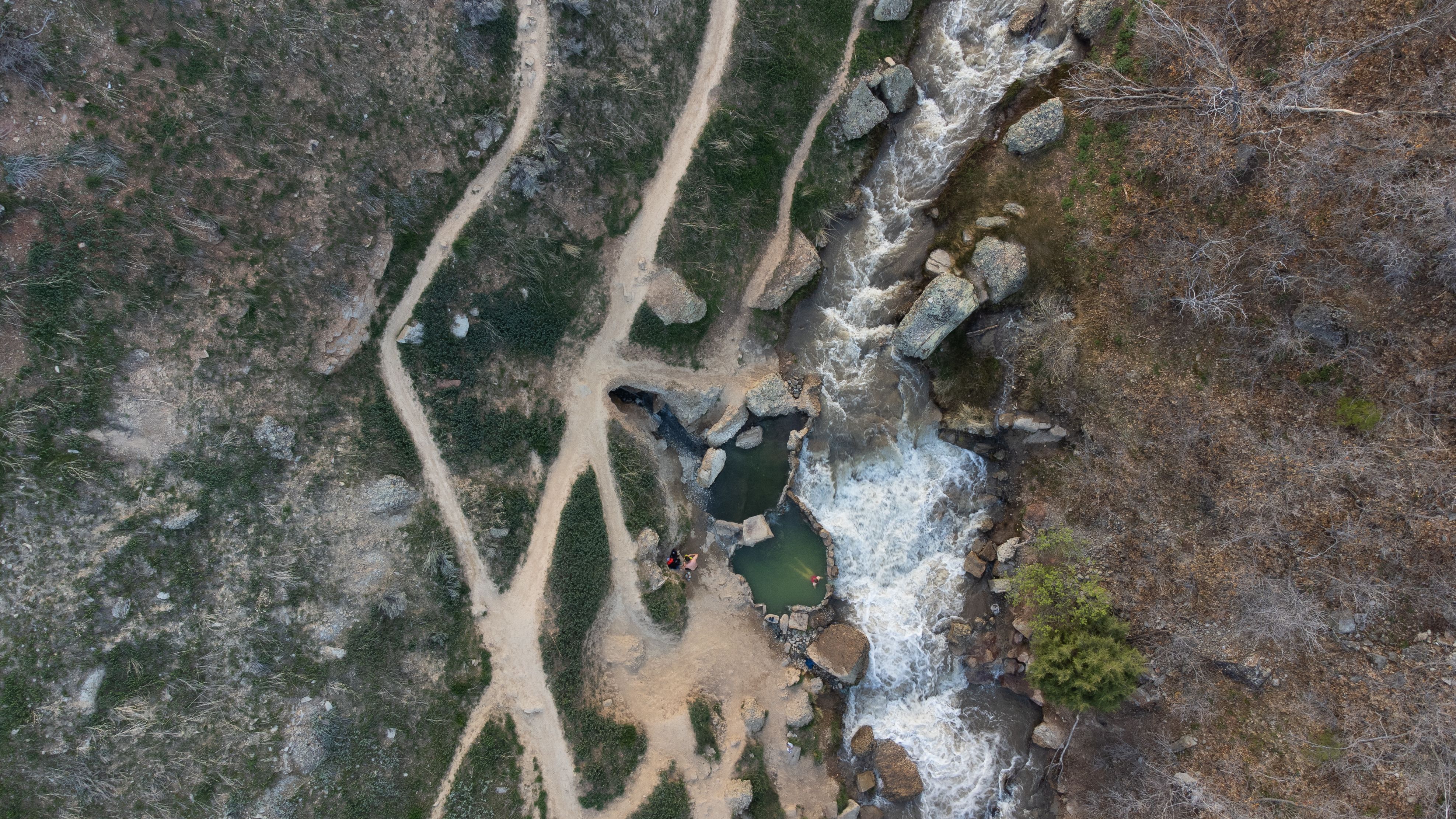 Drone shot capturing a bird's eye view of a waterfall and trails in Spanish Fork, Utah.