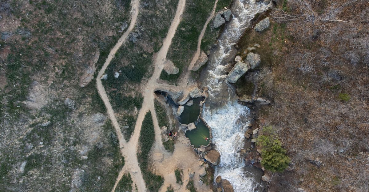 Drone shot capturing a bird's eye view of a waterfall and trails in Spanish Fork, Utah.