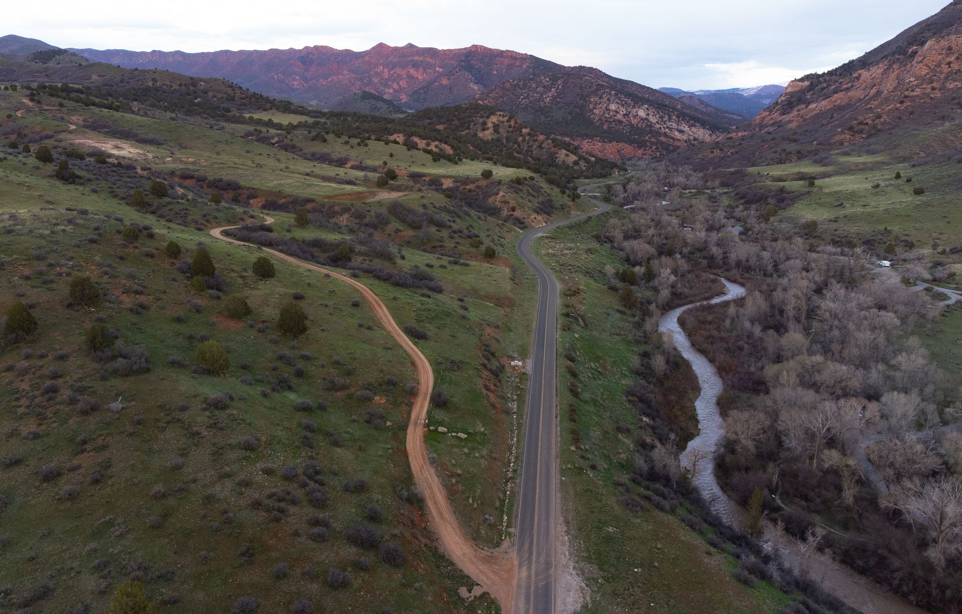 Drone shot of Spanish Fork Canyon, Utah, capturing winding roads and a flowing river.