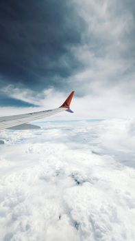 Scenic view of an airplane wing above the clouds, capturing the essence of air travel.