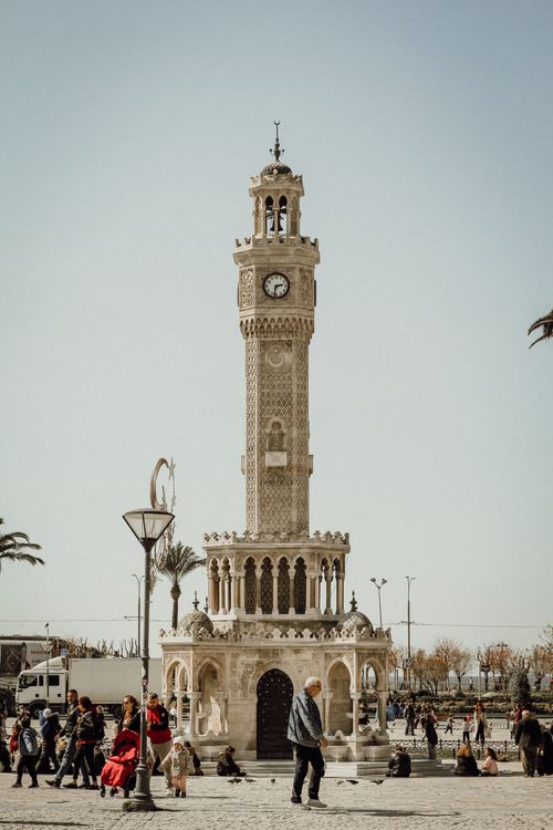 Free The iconic İzmir Clock Tower in Türkiye surrounded by people, showcasing Ottoman architecture. Stock Photo