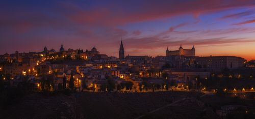 Free Stunning panorama of Toledo at sunset with illuminated historic architecture. Stock Photo