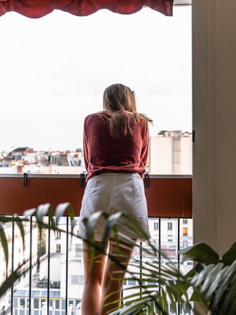 Woman in Red Dress Shirt and White Shorts Looking Out of Balcony · Free ...