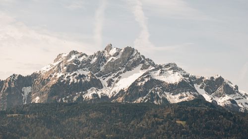 Free Beautiful view of snow-capped rugged mountain peaks under a clear sky. Stock Photo