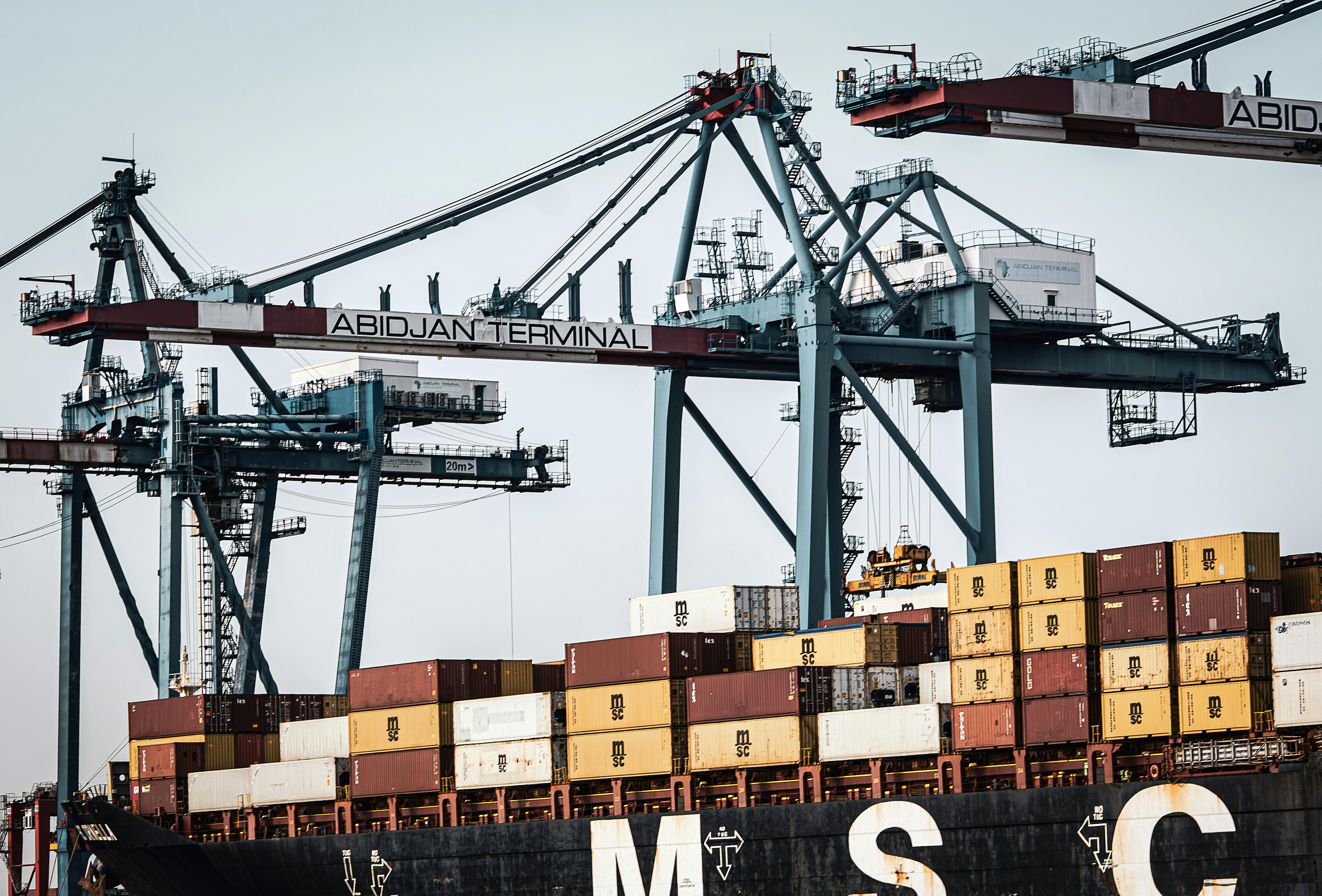 A view of large cranes and cargo containers at the busy Abidjan Terminal port.