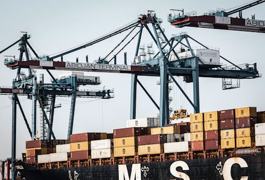 A view of large cranes and cargo containers at the busy Abidjan Terminal port.