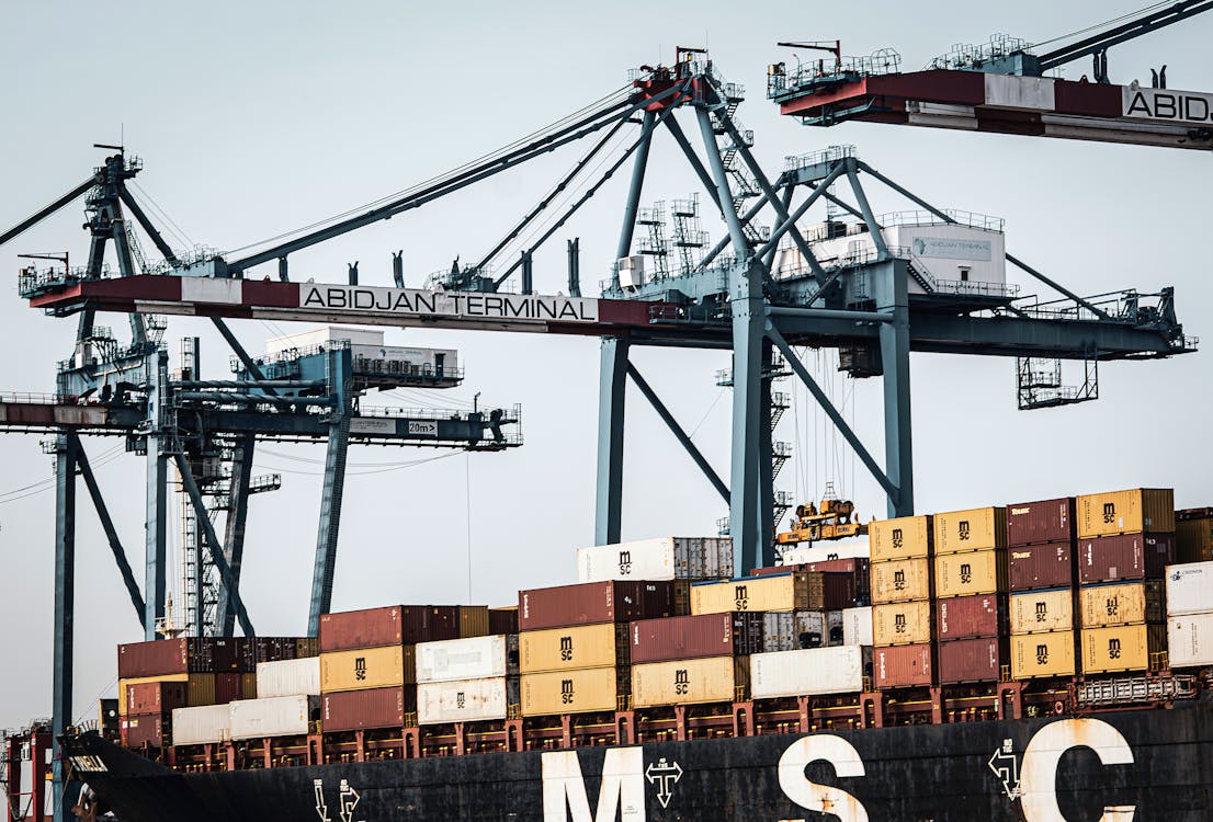Free A view of large cranes and cargo containers at the busy Abidjan Terminal port. Stock Photo