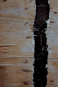 特写镜头中，粗糙质朴的木制表面有一道独特的黑色缝隙