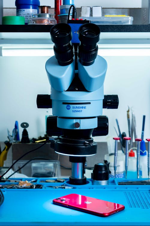 A microscope is used to examine a cell phone