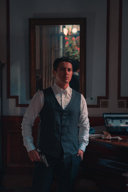 A man in a vest and tie standing in a room