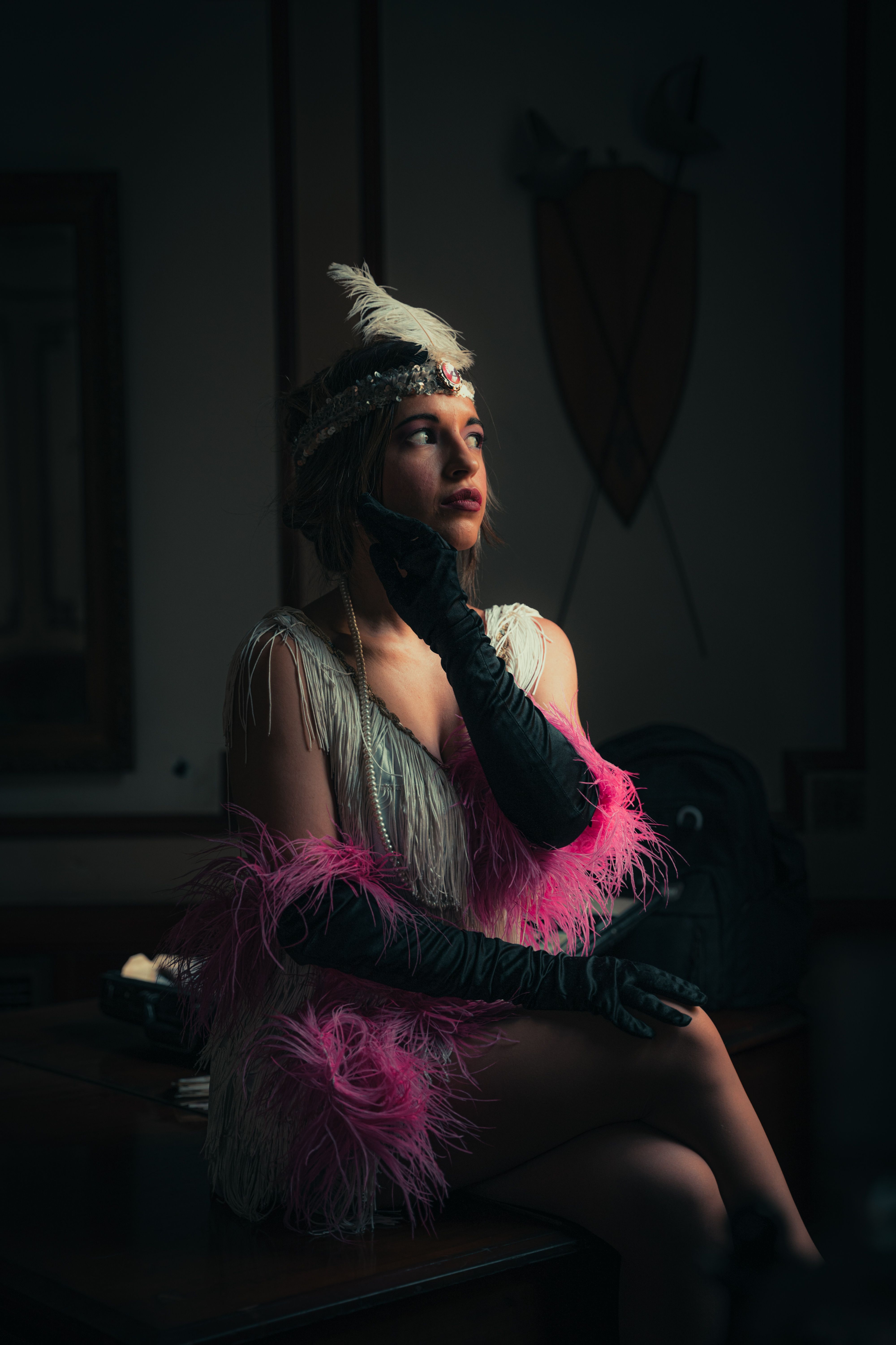 Elegant woman in a retro feathered costume, embodying 1920s glamour.