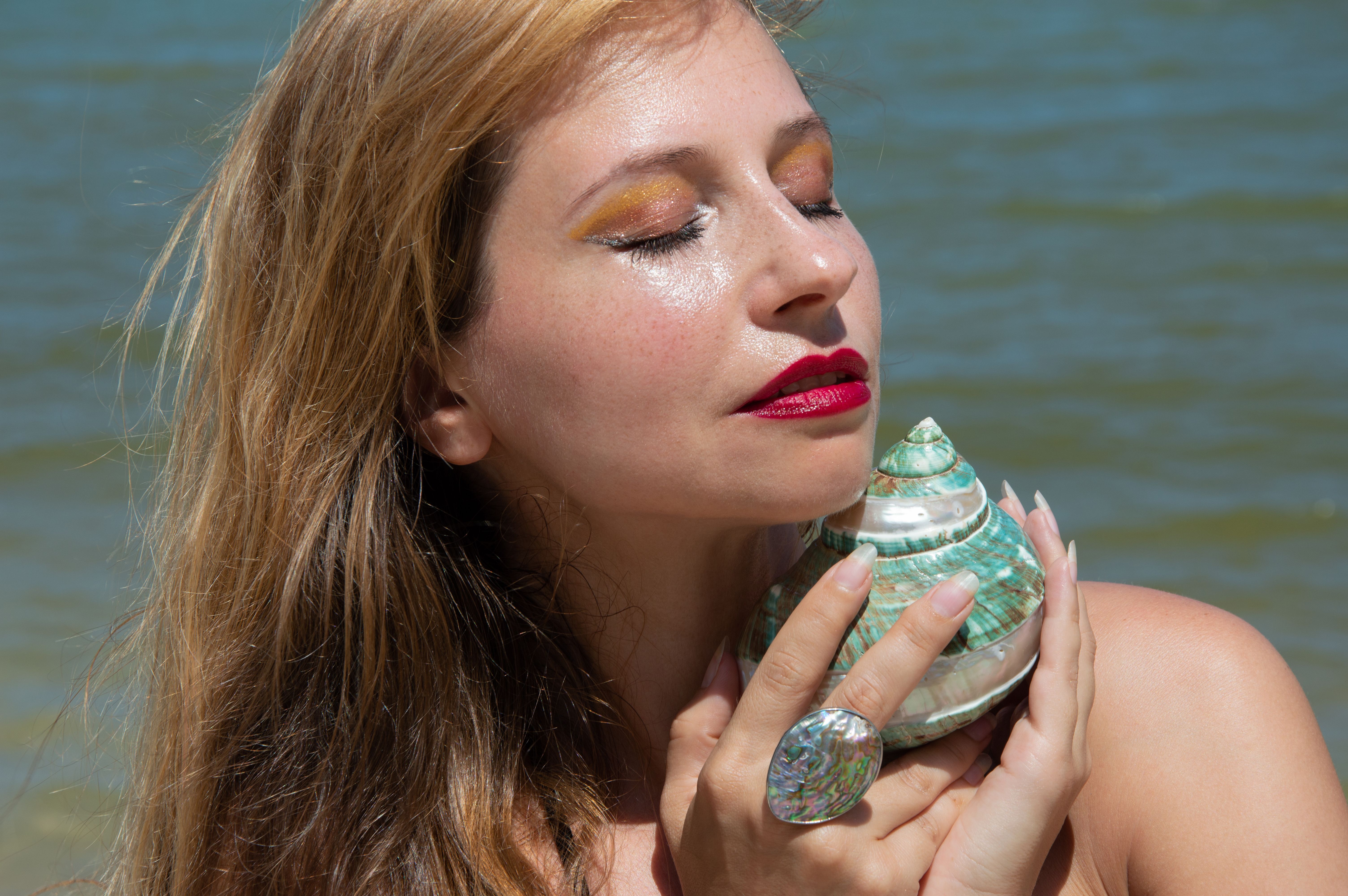 Woman with Green Seashell on the Beach · Free Stock Photo
