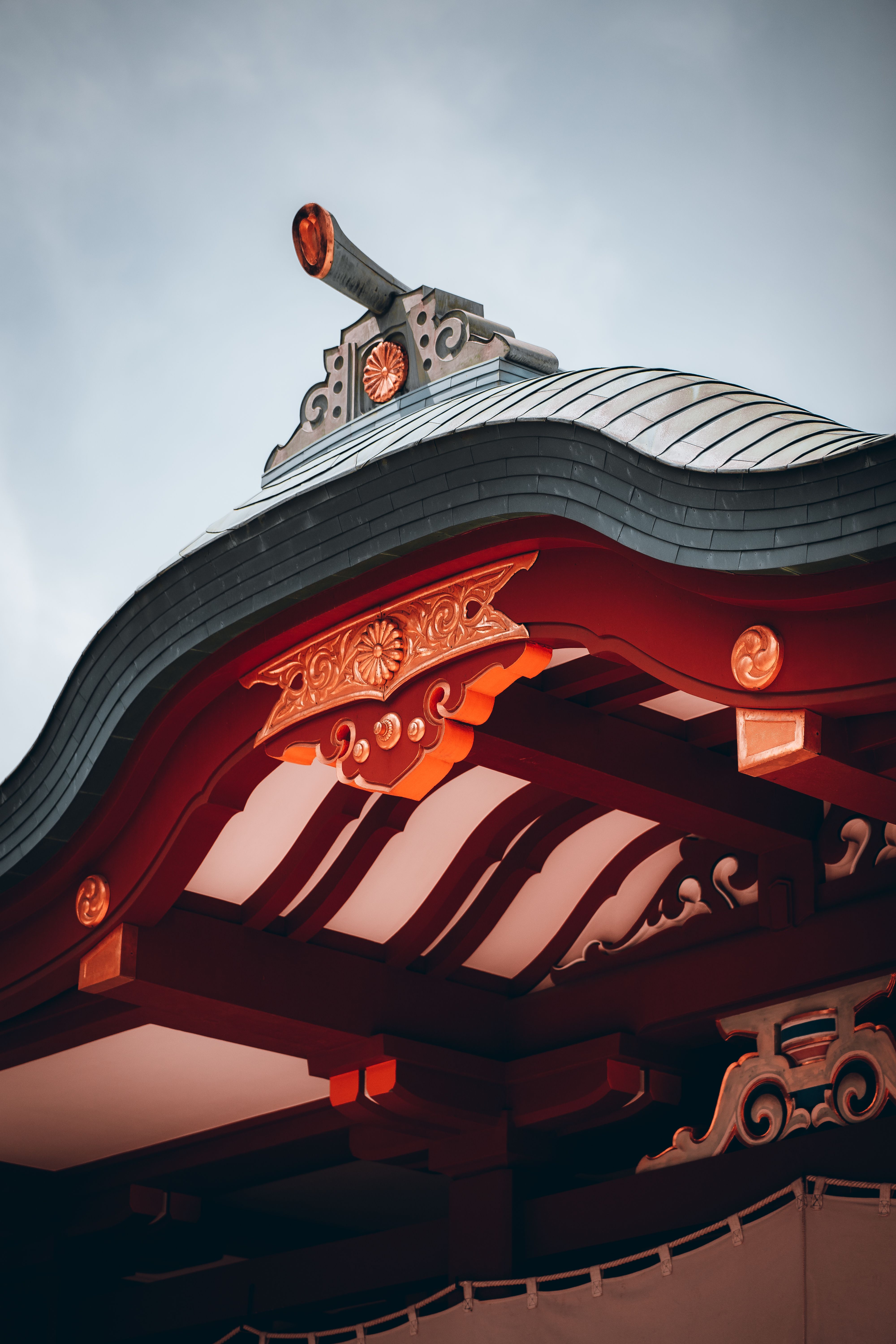 Close-up of a Japanese temple roof showcasing intricate wooden architecture in Tokyo, Japan.