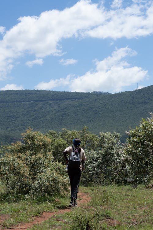 A man walking on a trail in the mountains