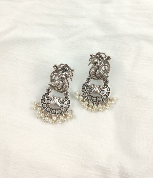Free peacock design earrings Stock Photo