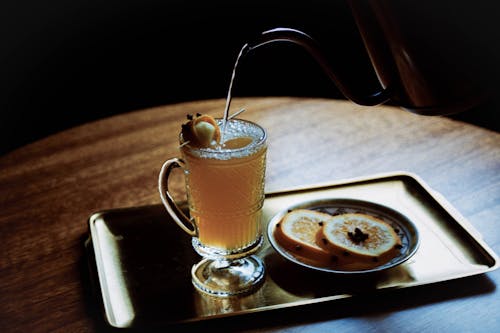 A tray with a glass of tea and a slice of cake