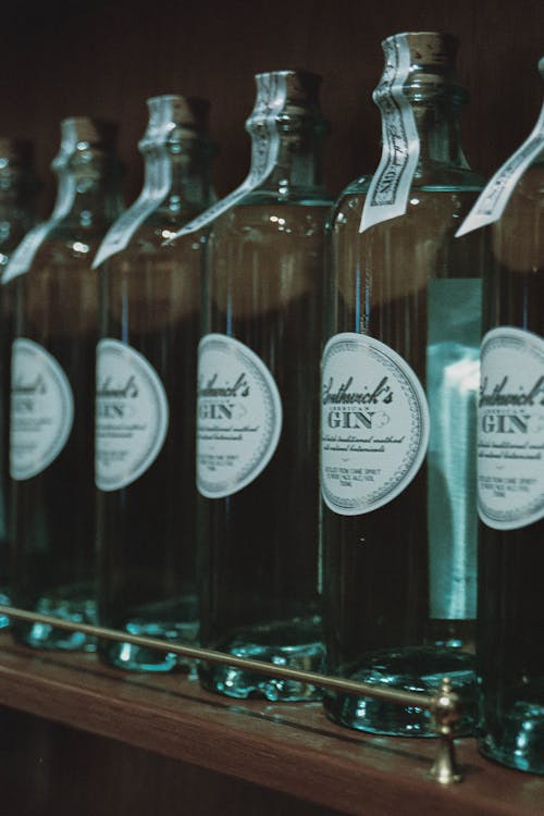 A row of bottles of gin on a shelf