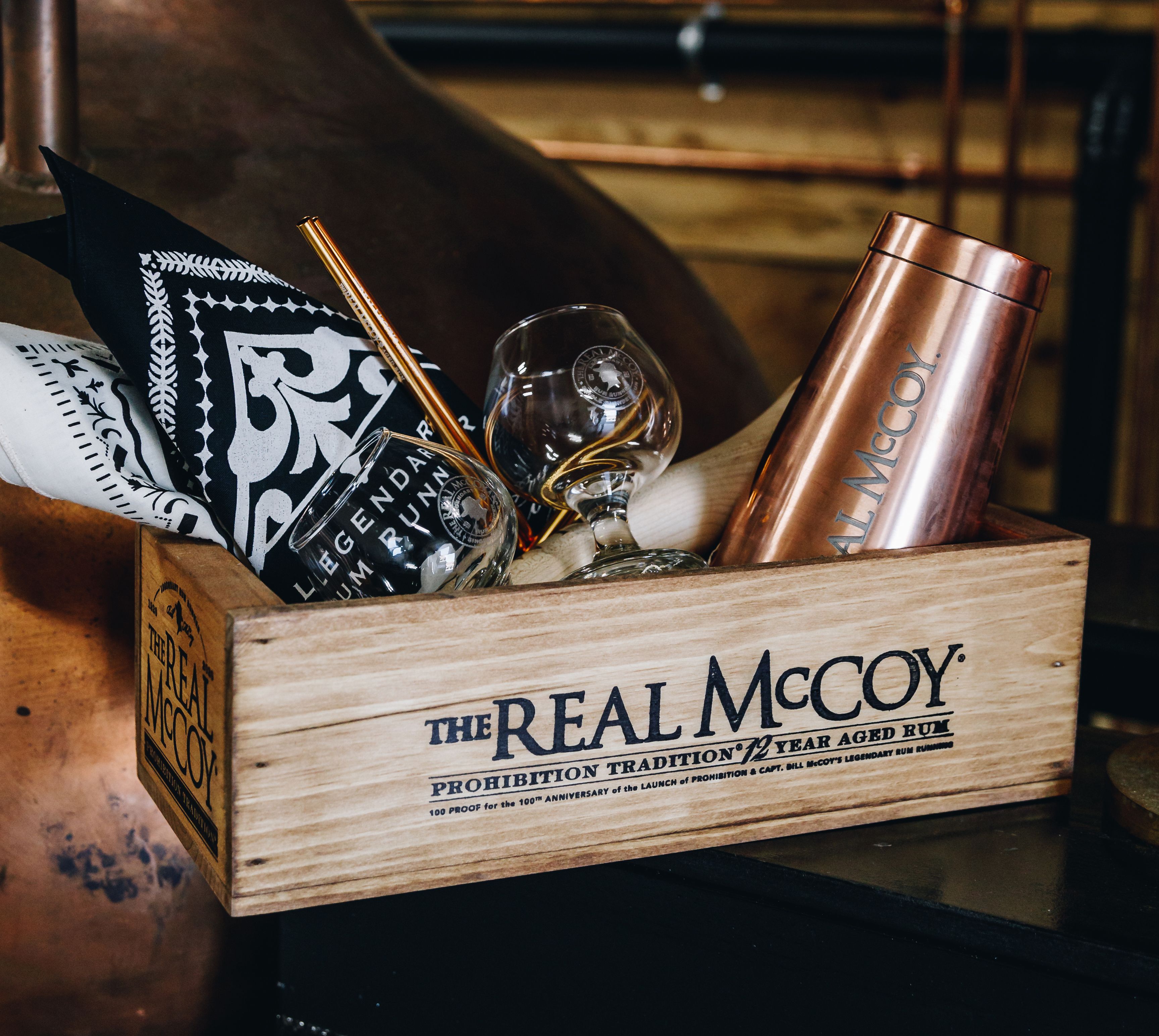 Chic arrangement of Real McCoy rum in a wooden crate with accessories.