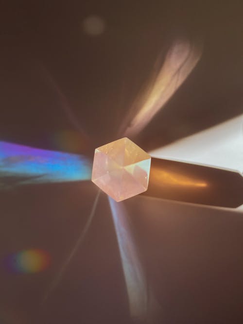 A close up of a crystal with a rainbow