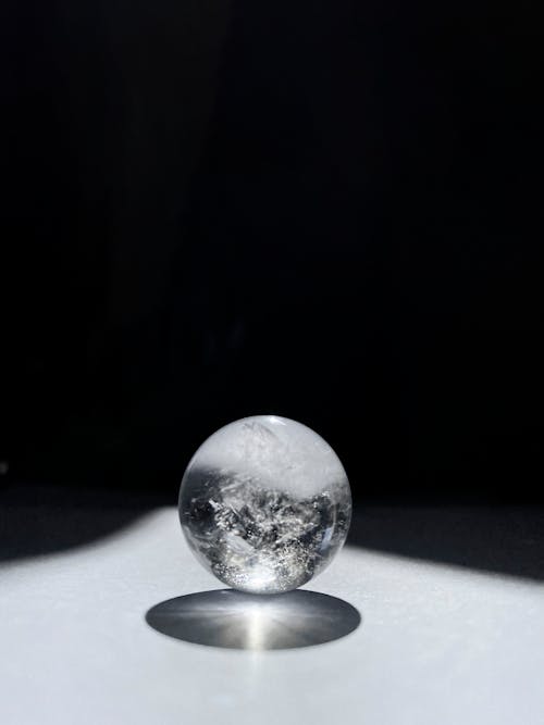 A glass ball with a shadow on it