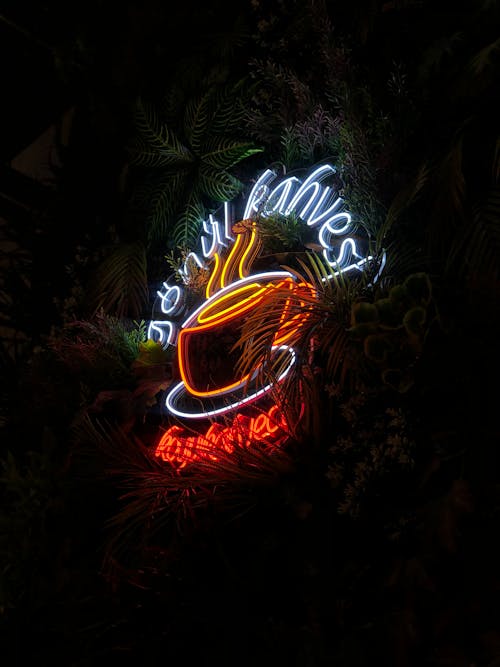 A neon sign with a coffee cup and a cup of tea