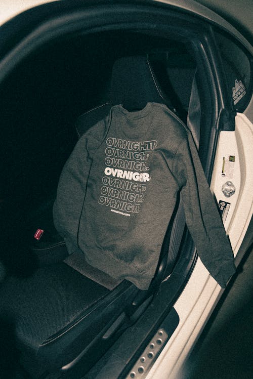 A sweatshirt is sitting in the back seat of a car