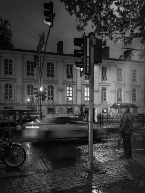 Free Dynamic black and white city street at night with blurred car motion. Stock Photo