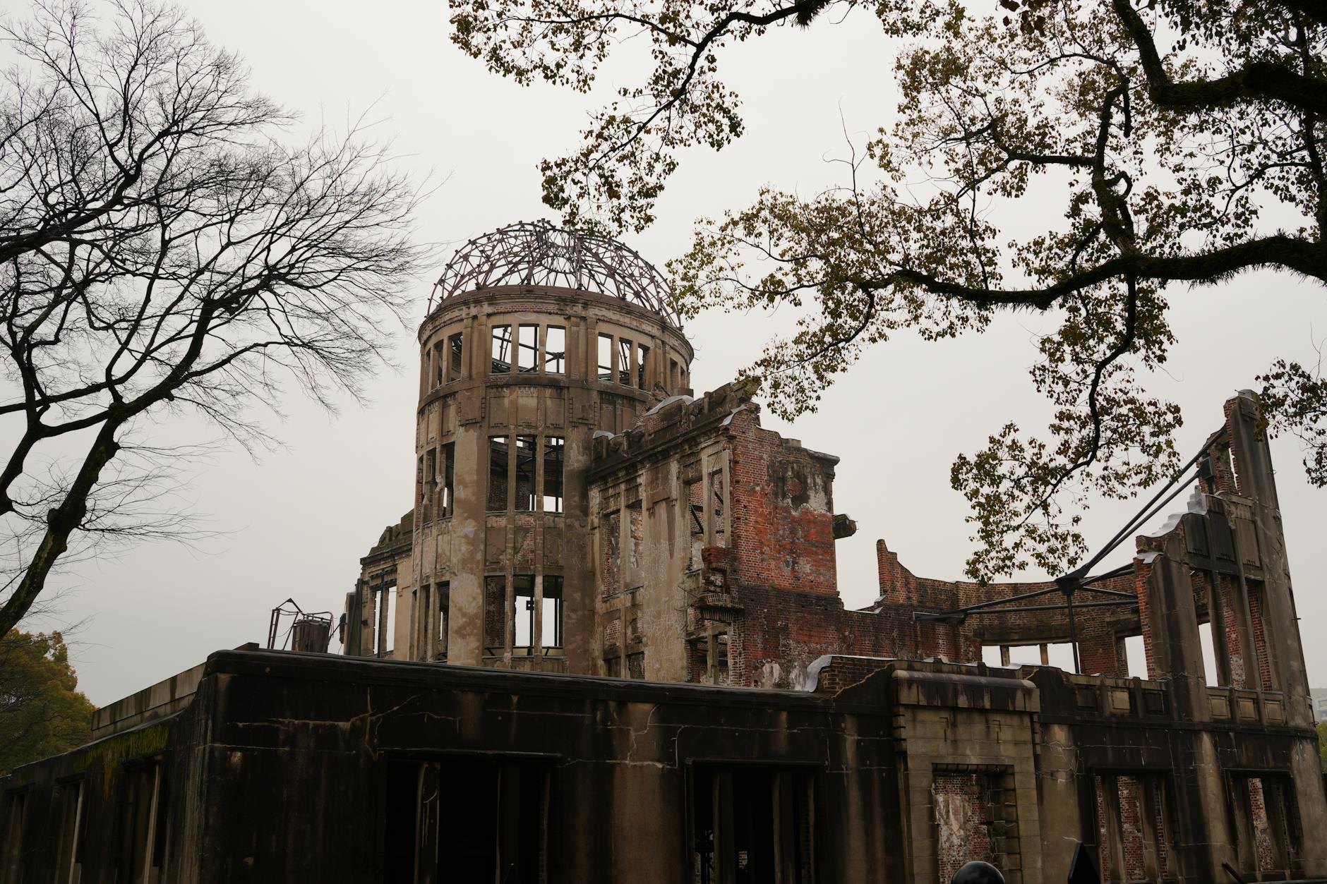 Hiroshima Peace Memorial with bare trees represents history and resilience.