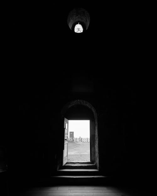 A black and white photo of an open door