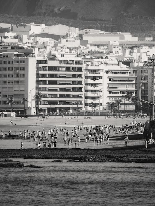 Black and white photo of people on the beach
