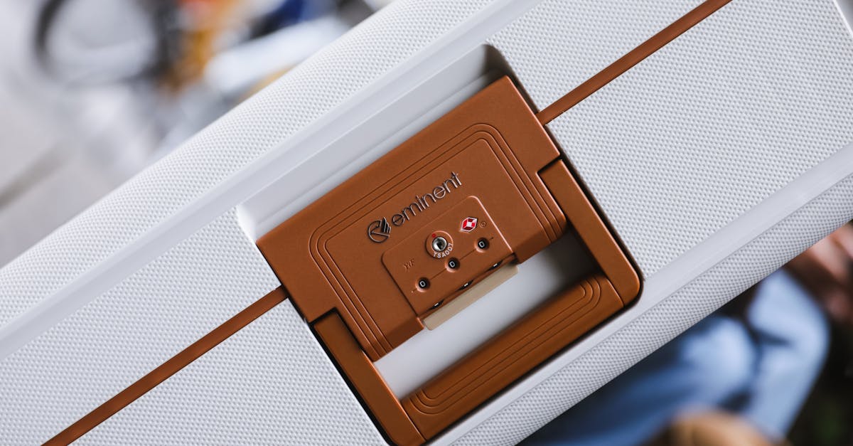 Photo by Eminent Luggage Close-up of a brown-handled white suitcase with a TSA lock, emphasizing travel security.