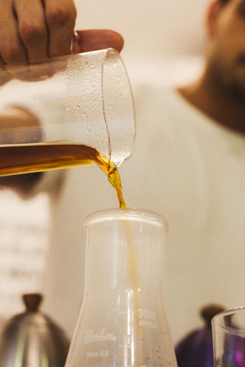 A person pouring coffee into a glass