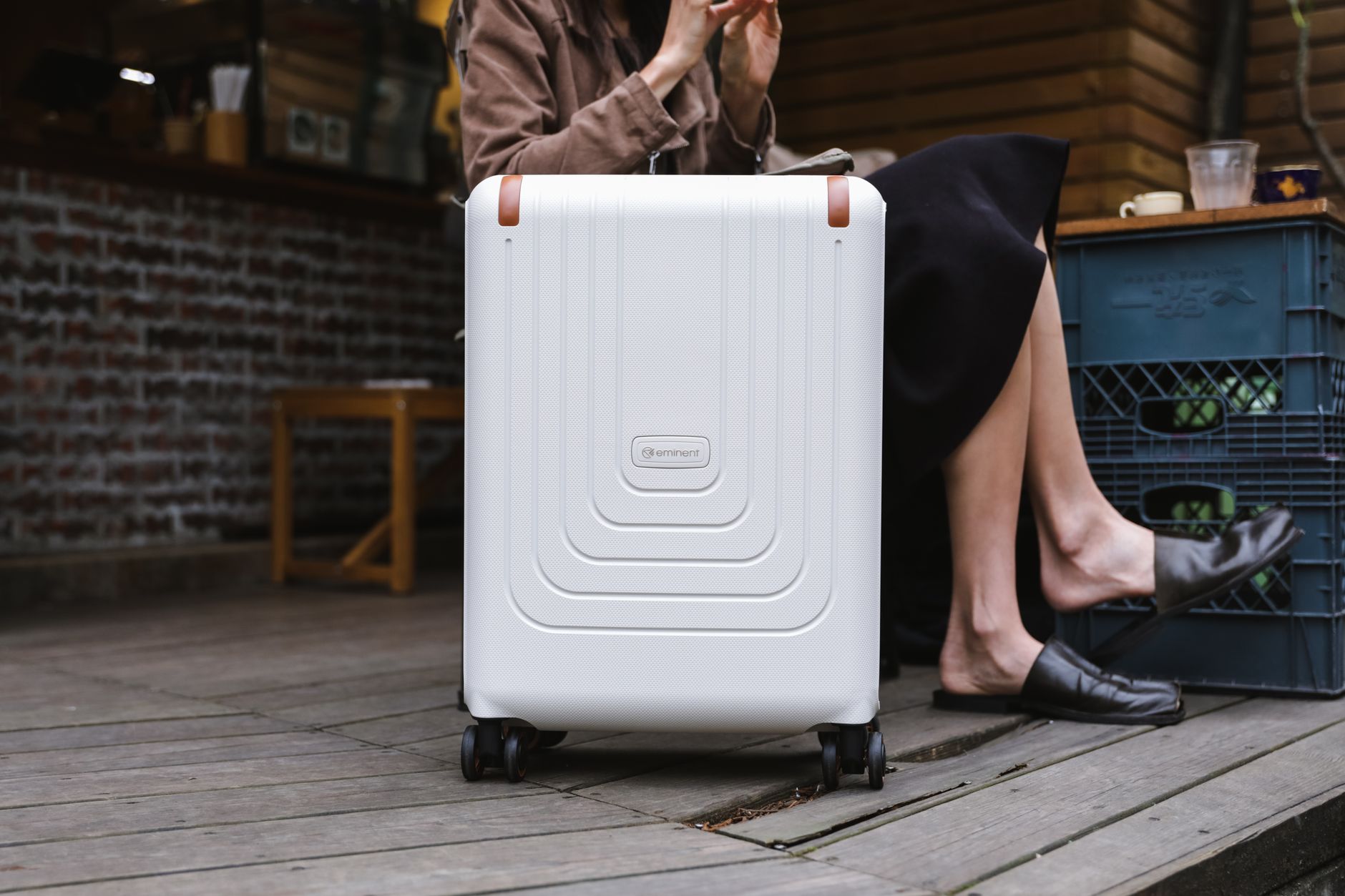 April Capsule Suitcase Open carry-on suitcase with neatly folded capsule wardrobe items for spring travel, including a light jacket, versatile tops, and comfortable shoes.