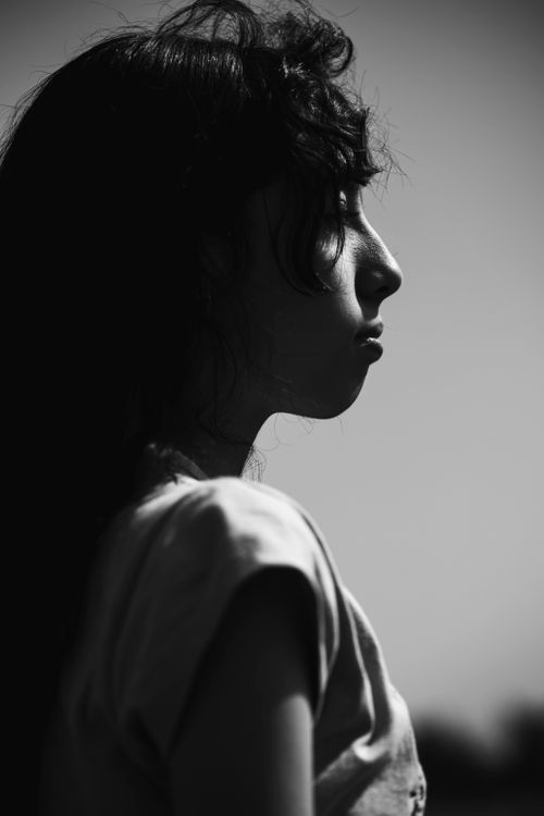 Free Artistic black and white portrait of a teenager in profile view. Stock Photo