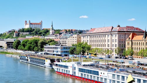 A river with a boat and buildings in the background