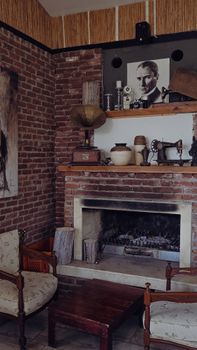 A vintage-themed room with a brick fireplace, antique decorations, and retro furniture.